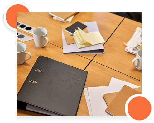 Workspace with documents and coffee cups, focusing on environment specification details.