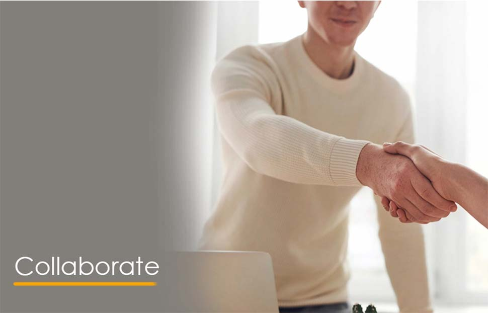 Two individuals shaking hands, symbolizing collaboration in project management.