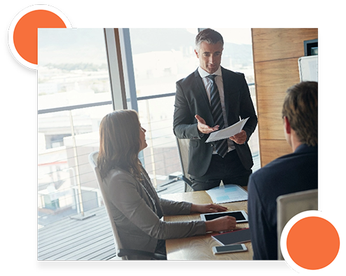 Team discussing business processes and infrastructure at a meeting table.