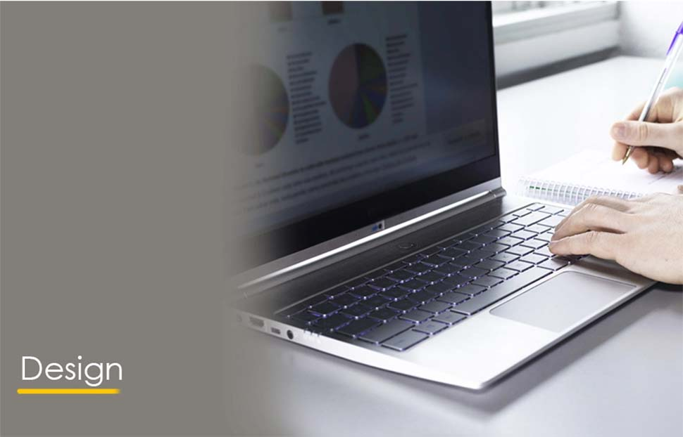 Person working on a laptop, focusing on design documents and project requirements.