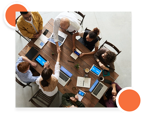 Aerial view of a group working on laptops and documents during a testing session.