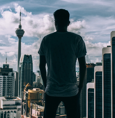 Director of Technology, Madhav S, standing with a city skyline in the background.