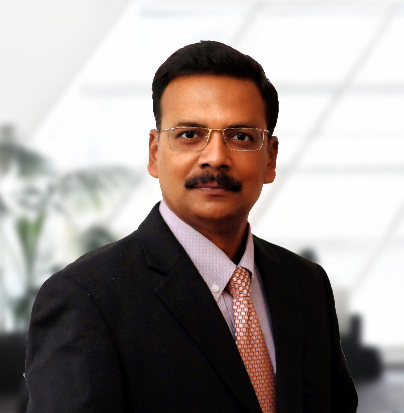 CEO of TechnicaX, Raj Boopathy, smiling in a suit against a professional background.
