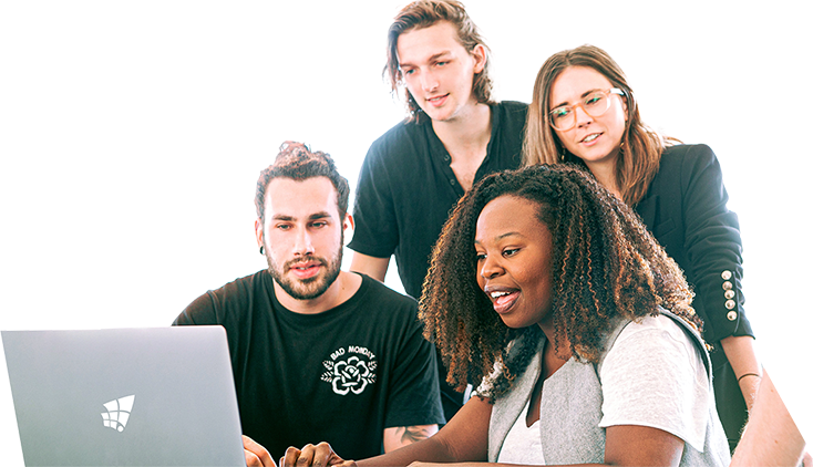 A diverse team of four people collaborating around a laptop, representing TechnicaX's custom software development solutions.